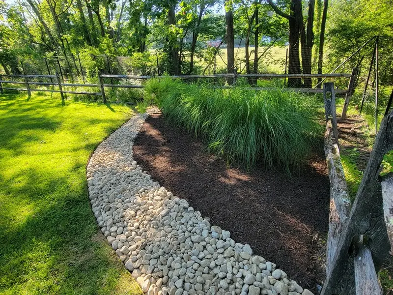 River-rock drainage swale & planting bed