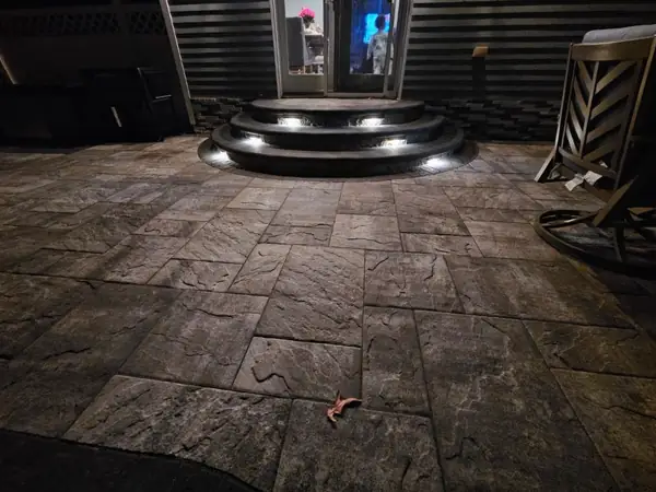 Large-format paver patio with lit steps